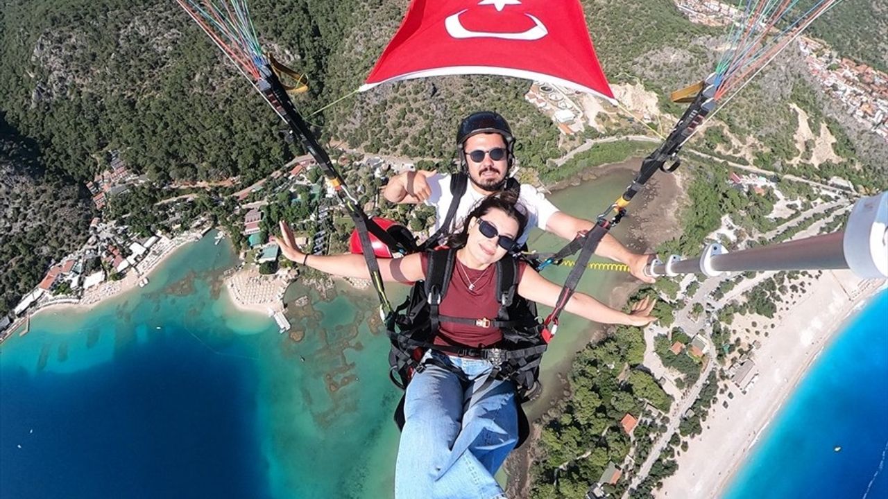 Fethiye'de Öğrenciler Bayraklarla Yamaç Paraşütü Uçuşu Gerçekleştirdi
