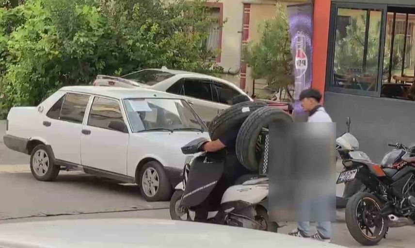 Kuryenin boynunda ve motosikletinde lastik taşıma görüntüleri tartışma yarattı