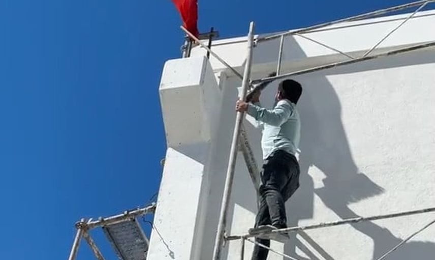 Kasabadaki iskeleye tırmanıp ters dönen Türk bayrağını düzeltti